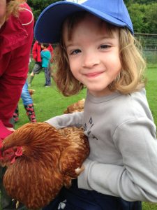 Holding a chicken Coombe Mill, Cornwall - Fun on the farm www.minitravellers.co.uk