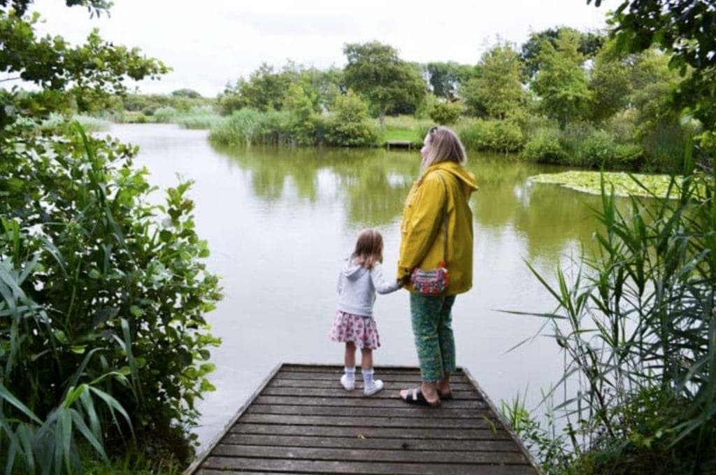 Family looking out over a lake. Part of my guide on Family Friendly Alternatives to Center Parcs