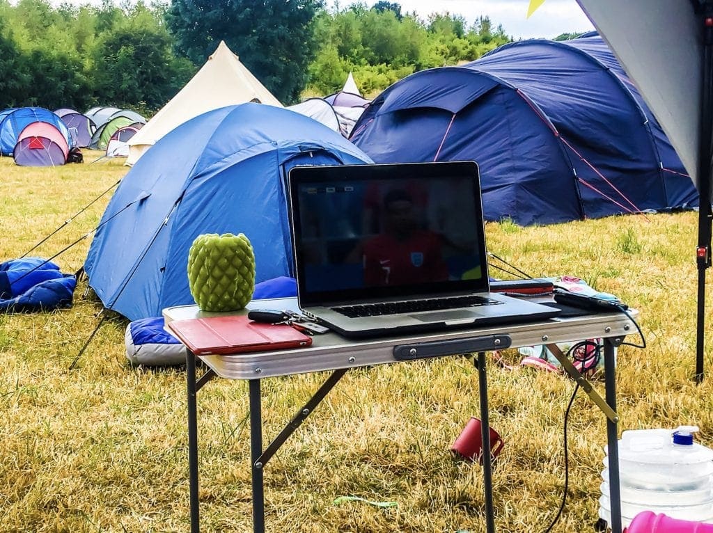 Relaxing under the Coleman Event Shelter FastPitch™ Shelter XL at a family friendly festival
